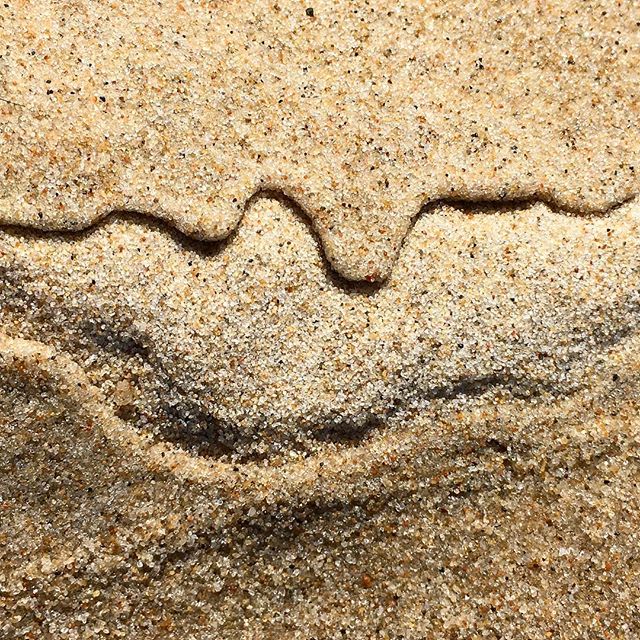 Swirly patterns on sand created by falling rain, photographed by Viveka Alvestrand Jewellery.